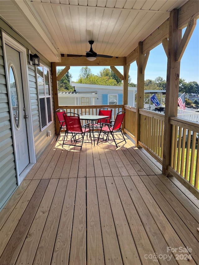 wooden terrace featuring ceiling fan