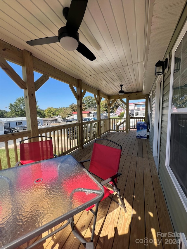 wooden deck featuring ceiling fan