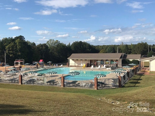 view of swimming pool with a lawn and a patio area