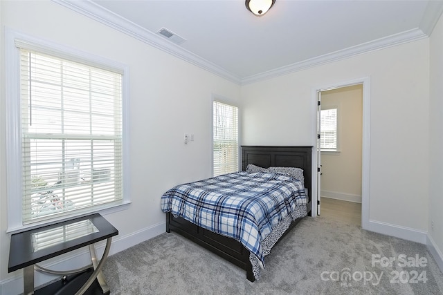 carpeted bedroom with ornamental molding