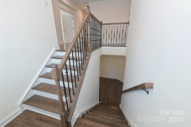 staircase with hardwood / wood-style flooring