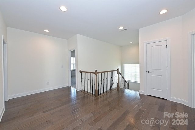 empty room featuring dark hardwood / wood-style flooring