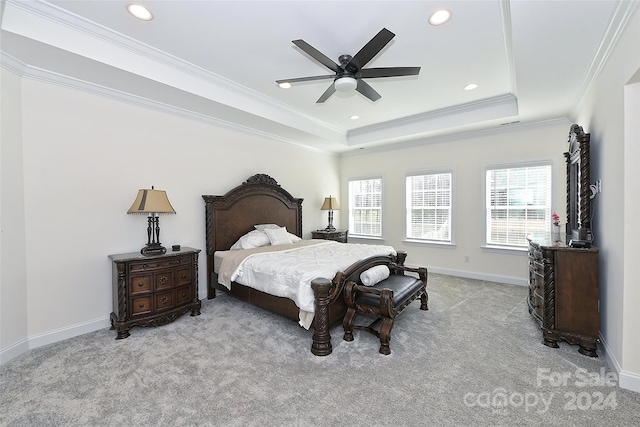 carpeted bedroom featuring ornamental molding, a raised ceiling, and ceiling fan