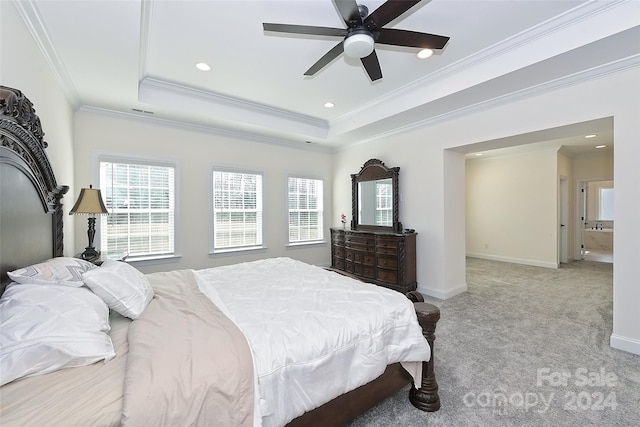 bedroom with ceiling fan, light carpet, ornamental molding, and a raised ceiling