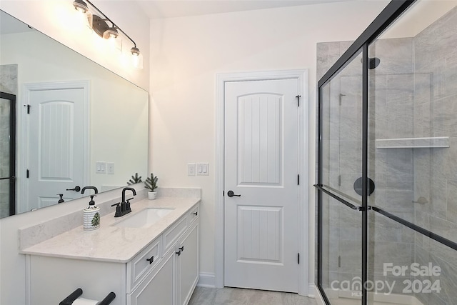 bathroom with vanity and an enclosed shower