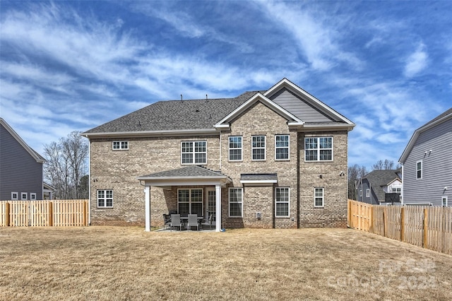 back of property featuring a yard and a patio area