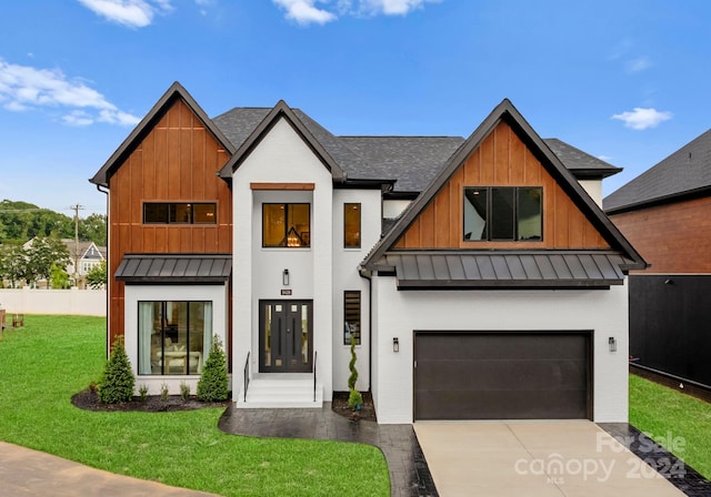 view of front of home with a front lawn and a garage