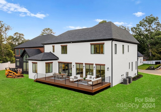 rear view of house with a wooden deck and a yard