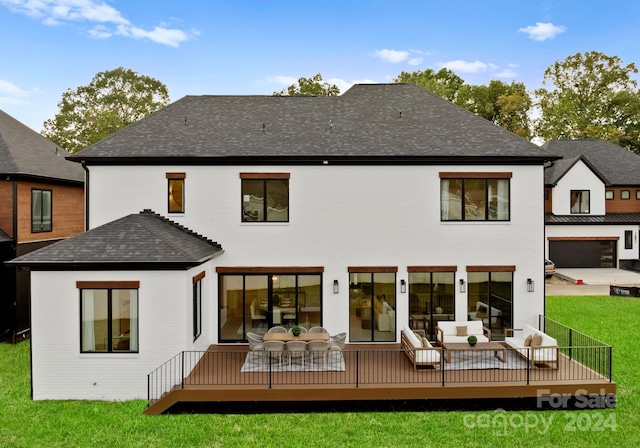 back of property with a wooden deck and a yard