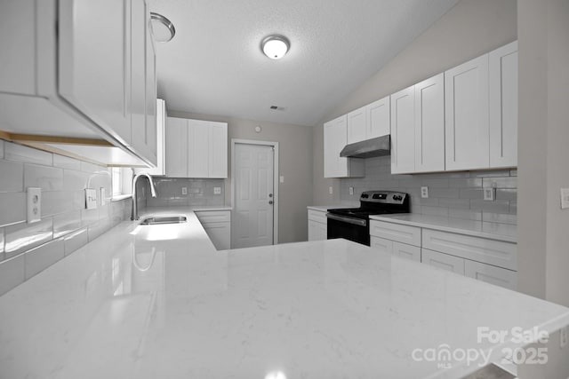 kitchen featuring sink, white cabinetry, vaulted ceiling, and electric stove