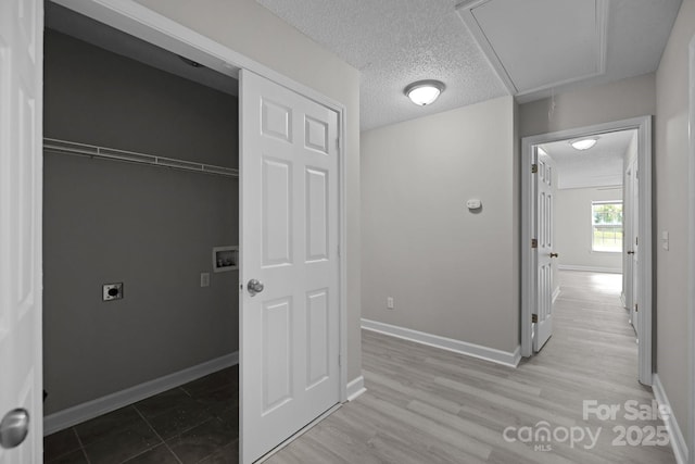 laundry room with a textured ceiling and hookup for an electric dryer