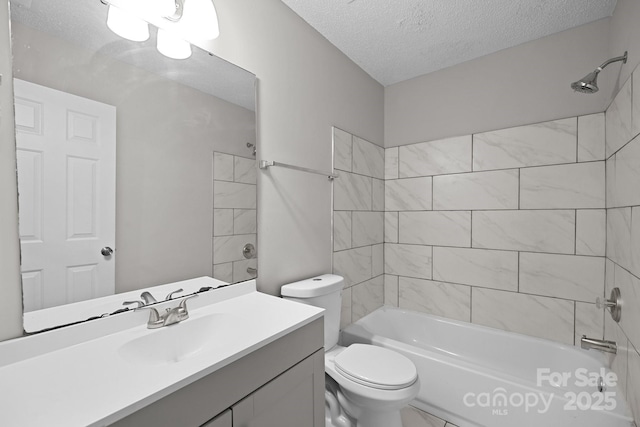 full bathroom with vanity, tiled shower / bath combo, a textured ceiling, and toilet