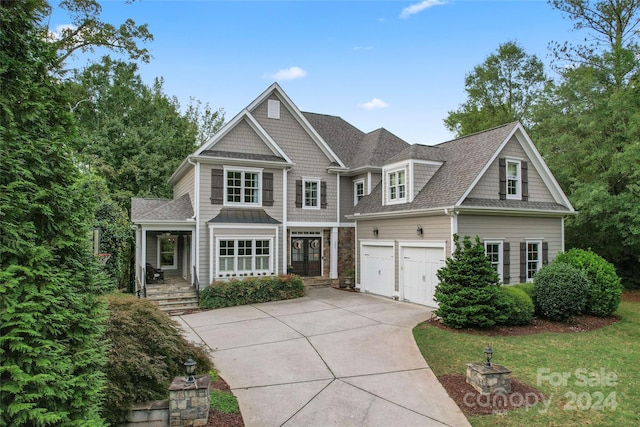 craftsman-style home featuring covered porch and a garage