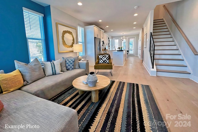 living room featuring a healthy amount of sunlight and light hardwood / wood-style flooring