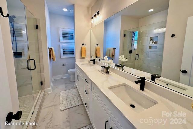 bathroom featuring an enclosed shower, vanity, and toilet