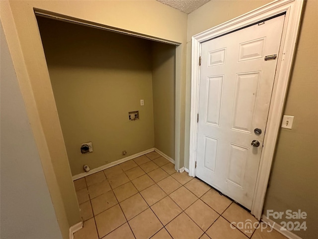 clothes washing area with hookup for an electric dryer, hookup for a gas dryer, and light tile patterned floors