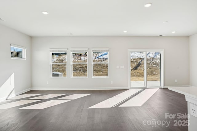 unfurnished living room with dark hardwood / wood-style flooring