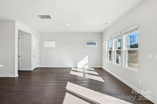 spare room with dark wood-type flooring