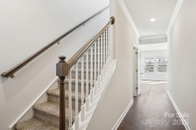 stairway featuring ornamental molding and wood-type flooring