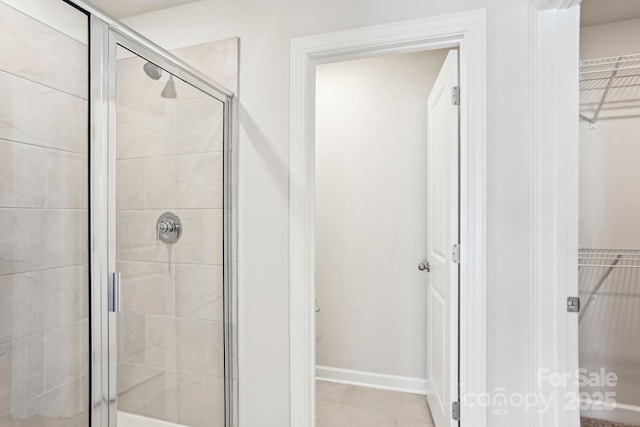 bathroom featuring tile patterned floors and an enclosed shower