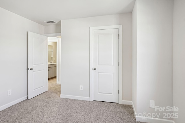 unfurnished bedroom with light colored carpet