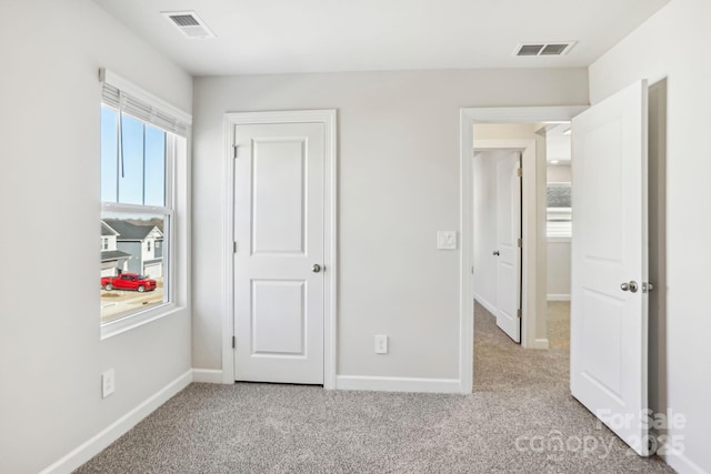 unfurnished bedroom with light carpet