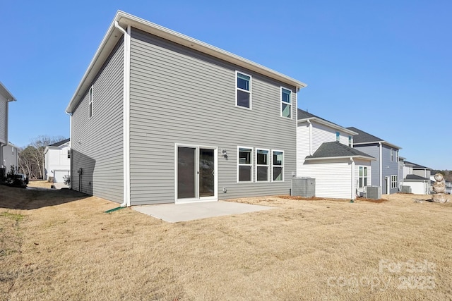 back of property featuring a yard, central AC unit, and a patio