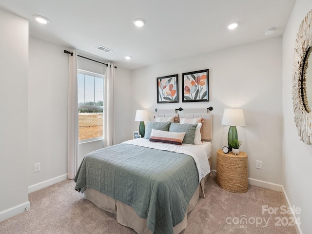 bedroom with light colored carpet