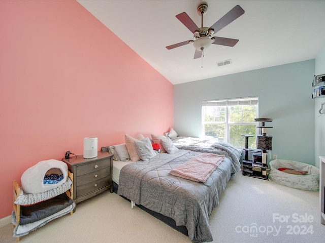 bedroom featuring ceiling fan, carpet floors, and vaulted ceiling