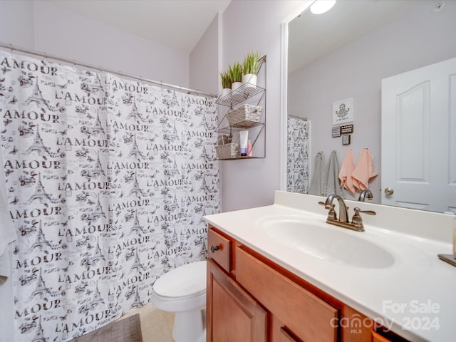 bathroom with tile patterned floors, vanity, and toilet