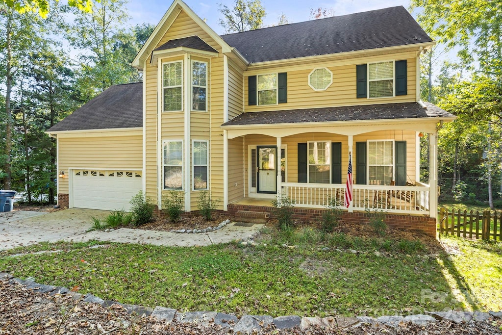 view of front facade featuring a porch and a garage