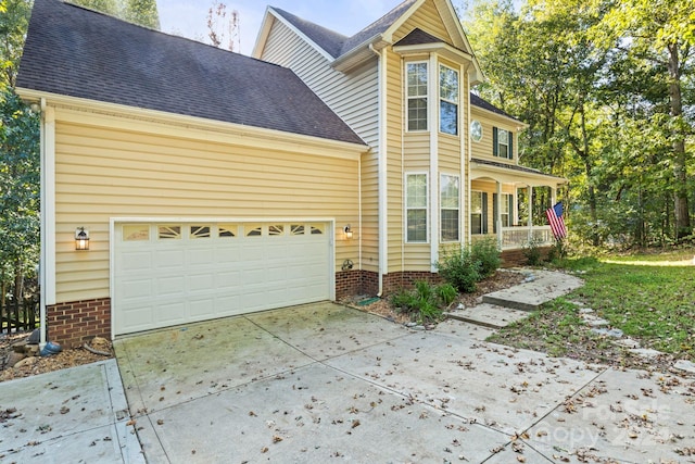 exterior space featuring a porch and a garage