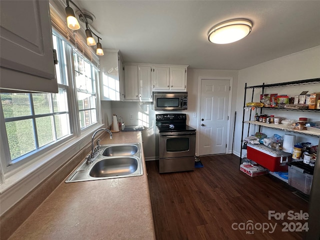 kitchen featuring appliances with stainless steel finishes, sink, dark hardwood / wood-style floors, and white cabinets