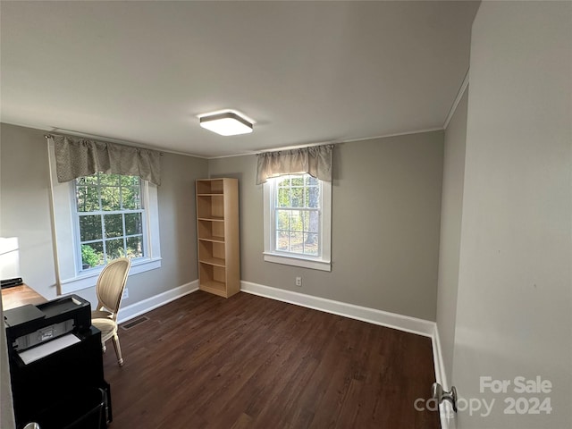 unfurnished office featuring crown molding and dark wood-type flooring