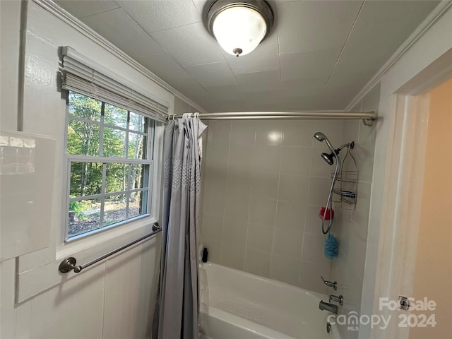 bathroom featuring crown molding and shower / tub combo