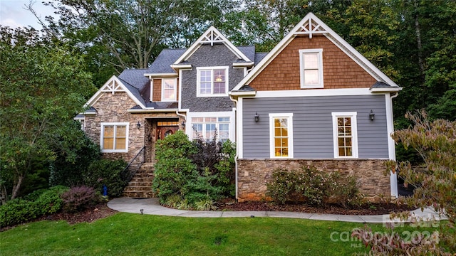 craftsman-style home with a front yard