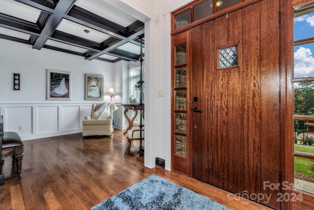 foyer entrance with dark wood-type flooring, coffered ceiling, and beam ceiling