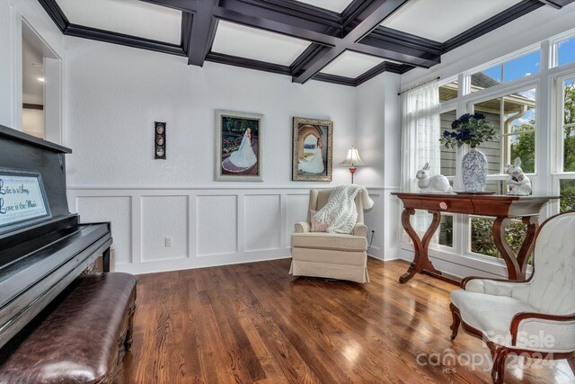 living area featuring coffered ceiling, beamed ceiling, dark hardwood / wood-style floors, and a healthy amount of sunlight