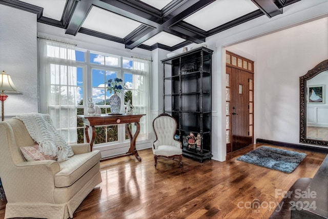 interior space featuring beam ceiling, coffered ceiling, ornamental molding, and wood-type flooring