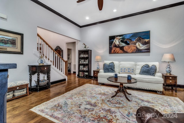 living room with ornamental molding, dark hardwood / wood-style flooring, and ceiling fan