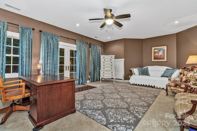 home office with ceiling fan, french doors, and light colored carpet