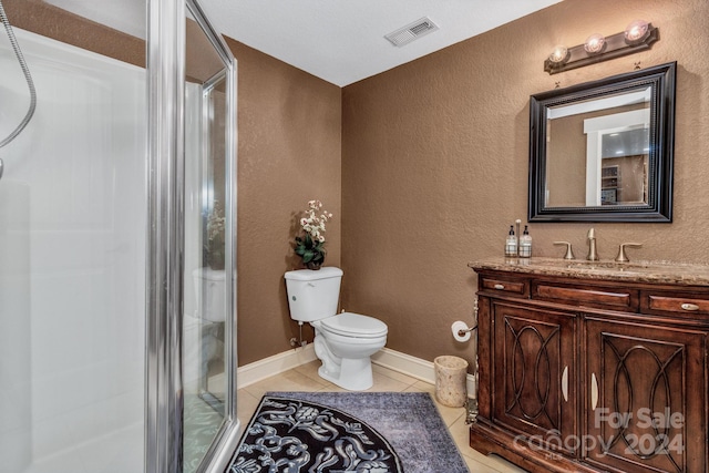 bathroom featuring tile patterned floors, toilet, an enclosed shower, and vanity