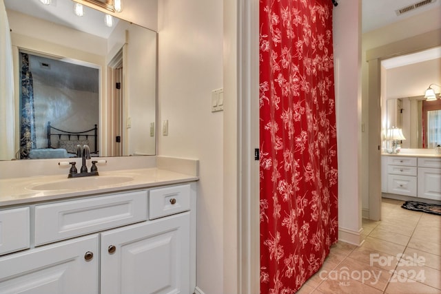 bathroom with tile patterned floors and vanity