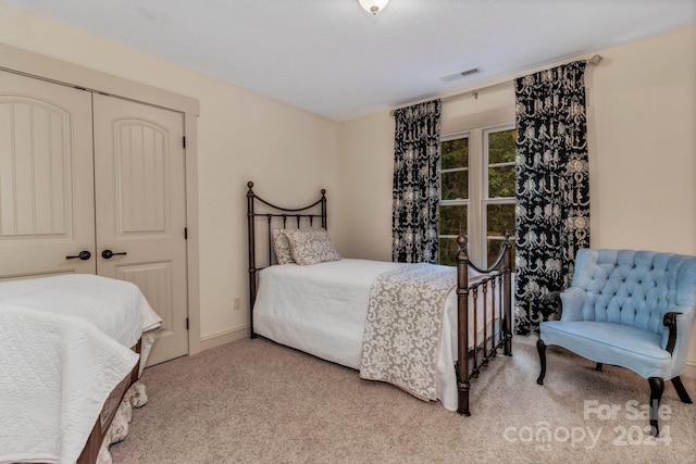 carpeted bedroom with a closet