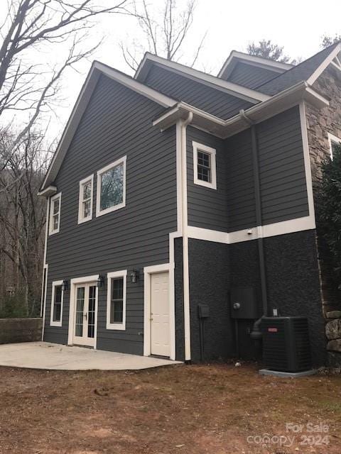 rear view of house with french doors, a patio, and central air condition unit