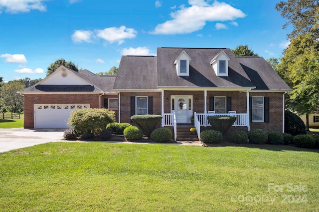 cape cod-style house featuring a garage, a porch, and a front yard