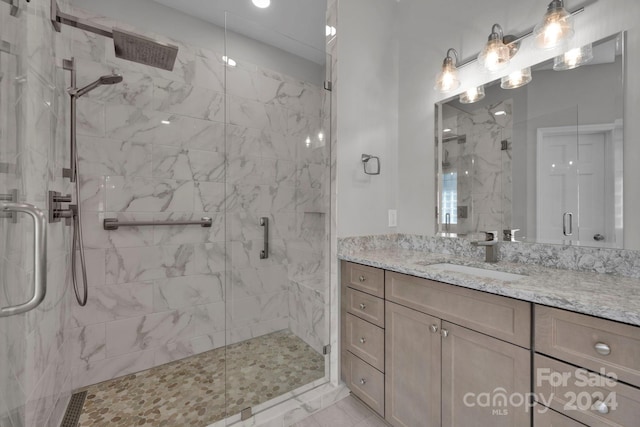 bathroom featuring walk in shower and vanity