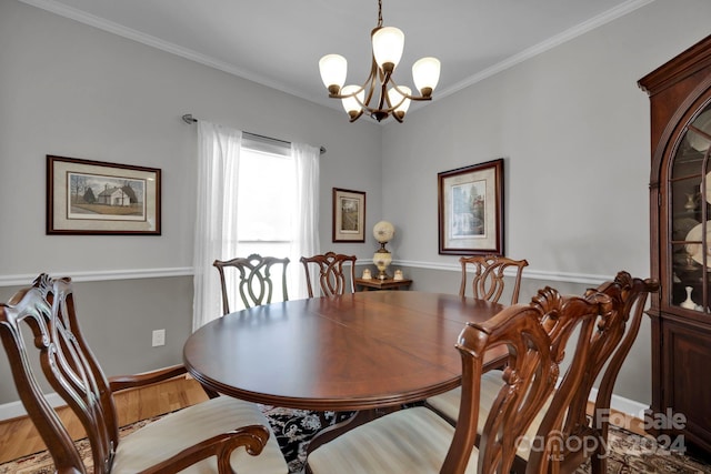 dining room featuring an inviting chandelier, hardwood / wood-style flooring, and crown molding