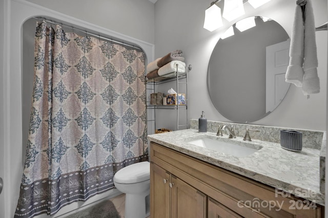 bathroom with a shower with curtain, vanity, toilet, and tile patterned floors