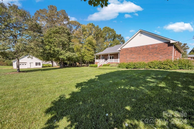 view of yard with a porch and a garage